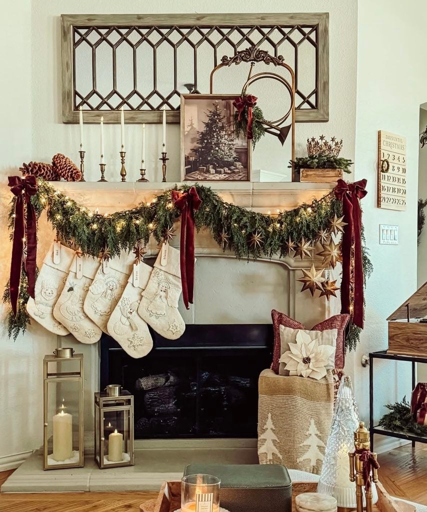 Christmas fireplace mantel decorated with garland, stockings, candles, and layered seasonal details for holiday inspiration.