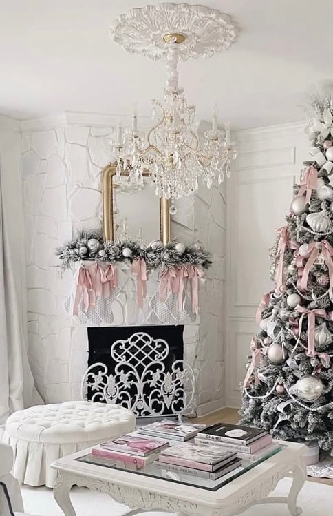 Christmas fireplace mantel styled with greenery and layered holiday decorations as inspiration for a variety of Christmas decor styles.