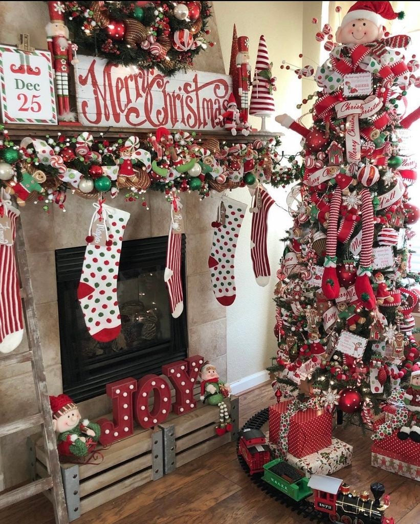 Whimsical Christmas fireplace mantel filled with playful decorations, greenery, colorful accents, and festive details.