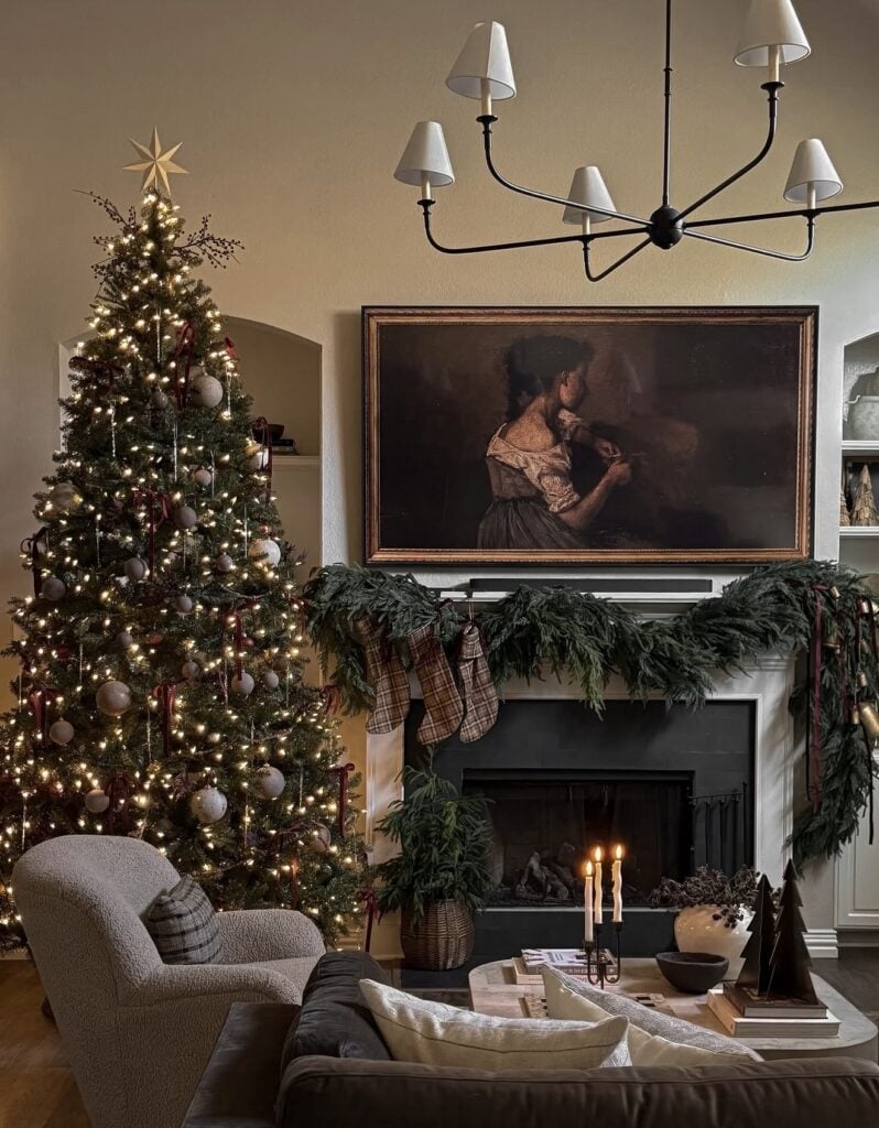 Classic Christmas mantel in the living room with lush greenery, hanging stockings, and layered garland in a Ralph Lauren-inspired holiday style with plaid stockings