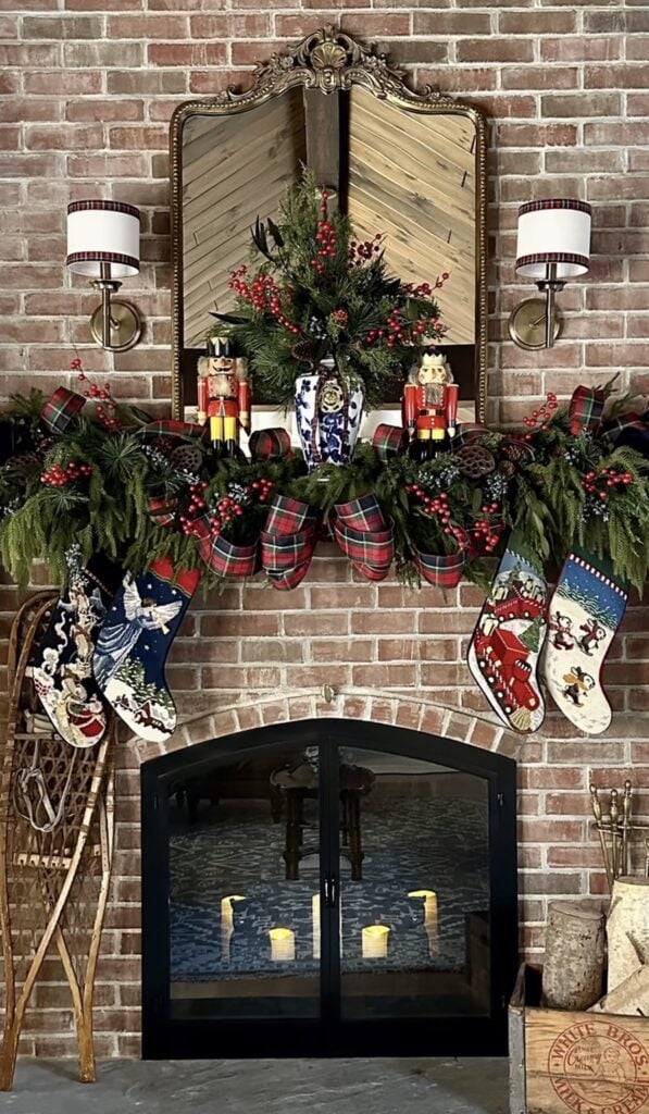 Classic Christmas mantel inspired by Ralph Lauren with layered greenery, plaid bows, nutcrackers, traditional colors, and rich holiday details.