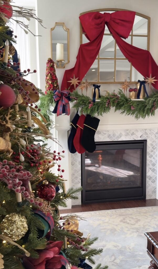 Classic Ralph Lauren-style Christmas mantel with rich greenery and layered traditional holiday decor with oversized bow