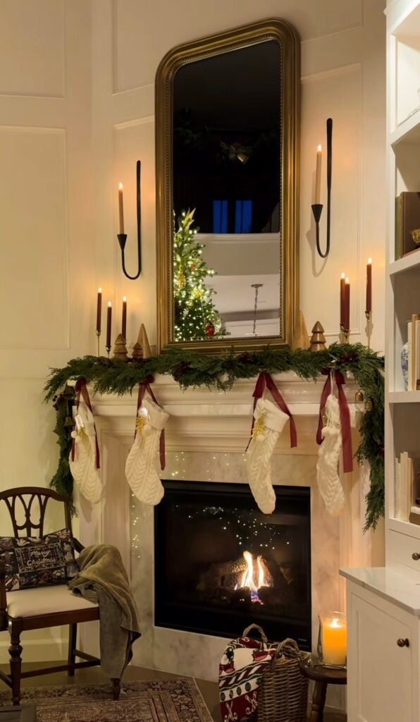 Christmas mantel styled in a classic Ralph Lauren aesthetic with greenery, small velvet bows, traditional details, and warm seasonal accents.
