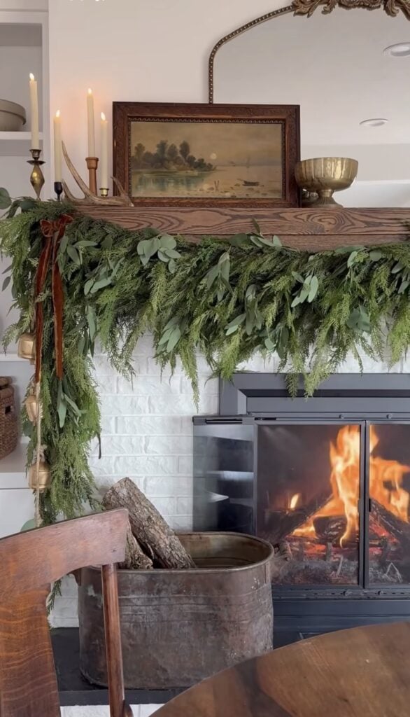 Ralph Lauren-inspired Christmas mantel with antlers, greenery, and rustic equestrian holiday accents.