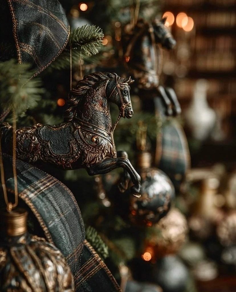Close-up of a Ralph Lauren-inspired Christmas tree with an equestrian horse ornament, tartan ribbon, deep green branches, burgundy accents, and warm metallic details.