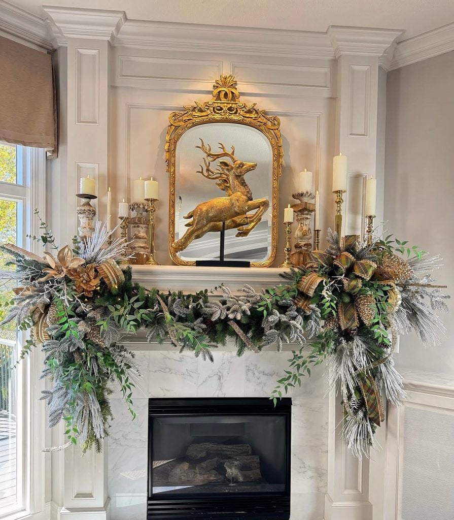 Elegant gold Christmas fireplace mantel decorated with metallic ornaments, greenery, candles, and warm holiday accents.