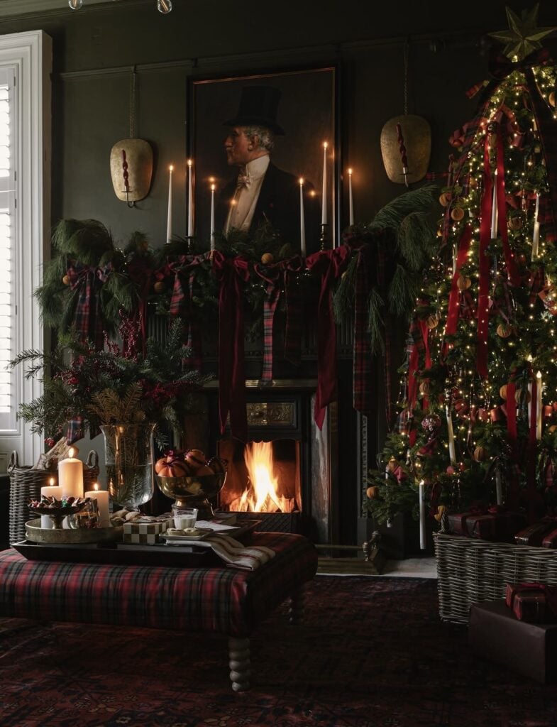 Moody classic Christmas mantel with deep colors, greenery, and dramatic Ralph Lauren-inspired holiday decor.