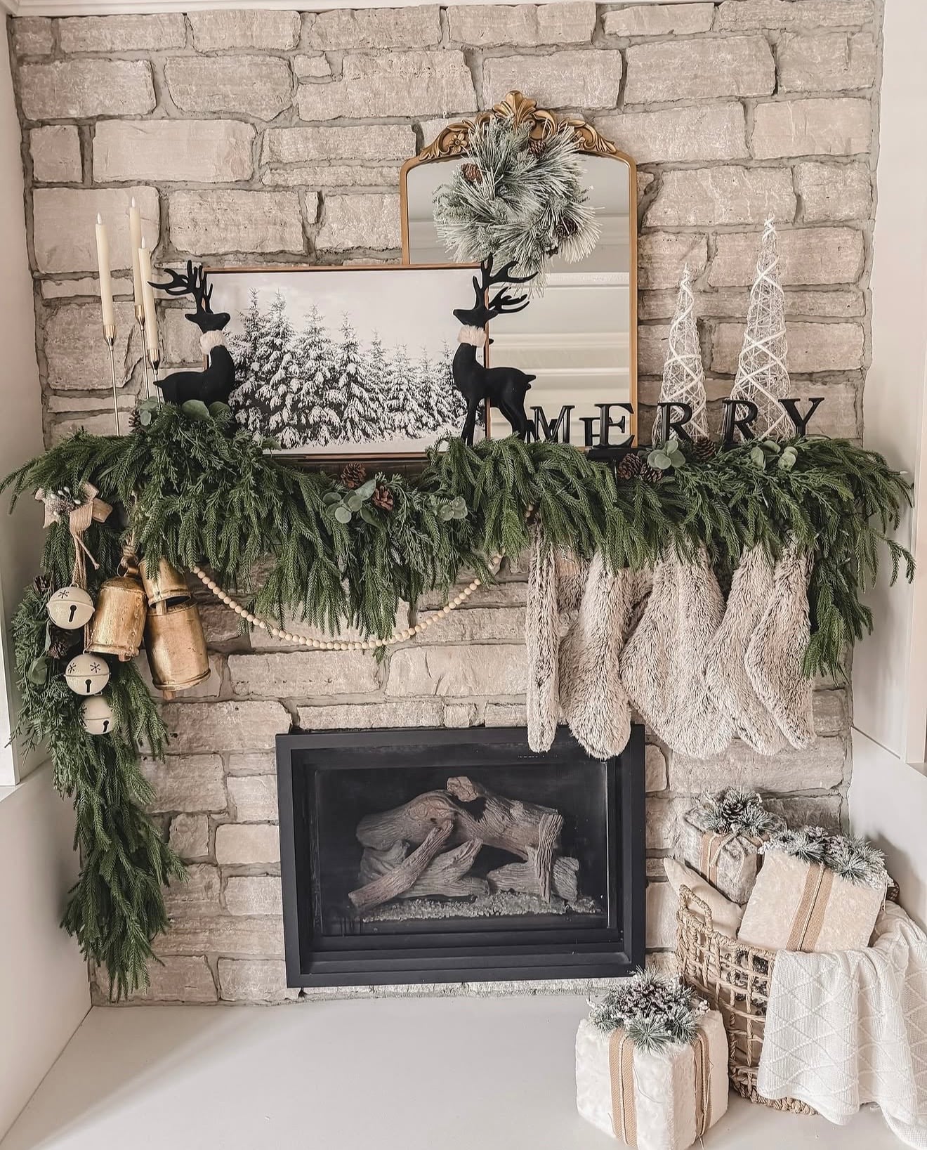Neutral Christmas mantel with greenery, reindeer accents, and understated Ralph Lauren-inspired holiday decor.