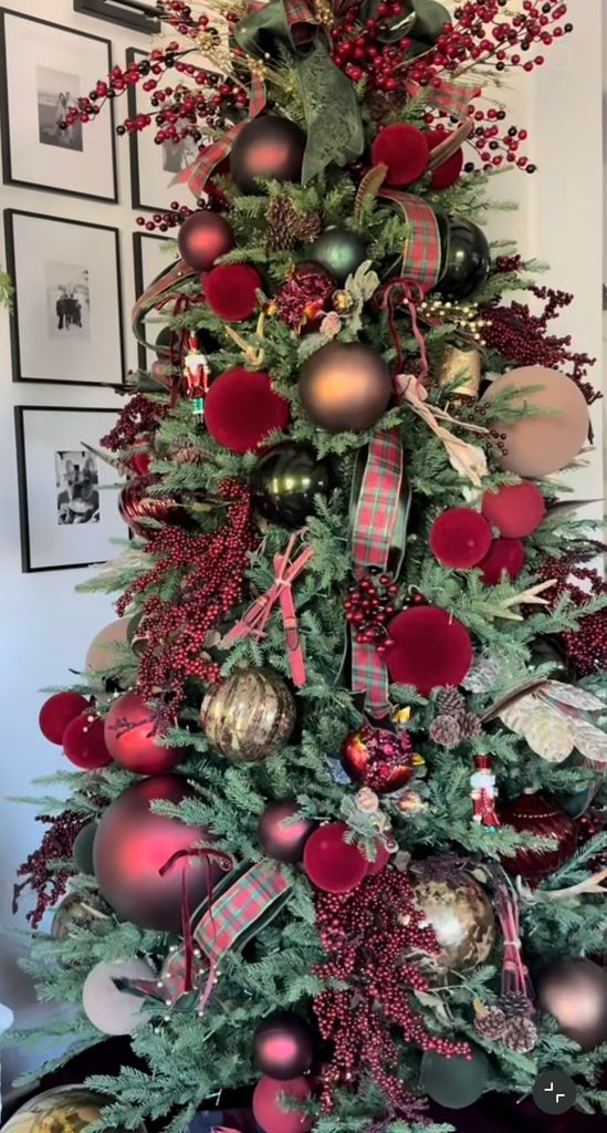 Ralph Lauren-style Christmas tree with burgundy ornaments, plaid ribbon, red berries, metallic finishes, deep green accents, and layered vintage-inspired decorations.