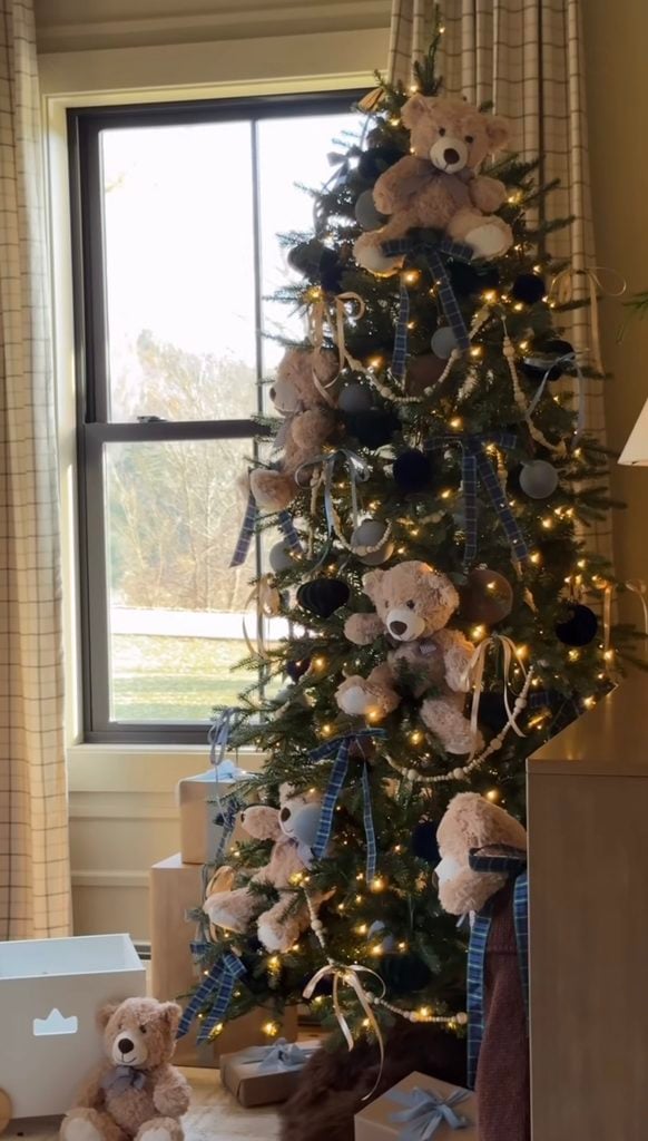 Ralph Lauren Christmas tree decorated with oversized teddy bears, navy ornaments, blue plaid ribbon, warm white lights, beaded garland, and soft neutral holiday accents.