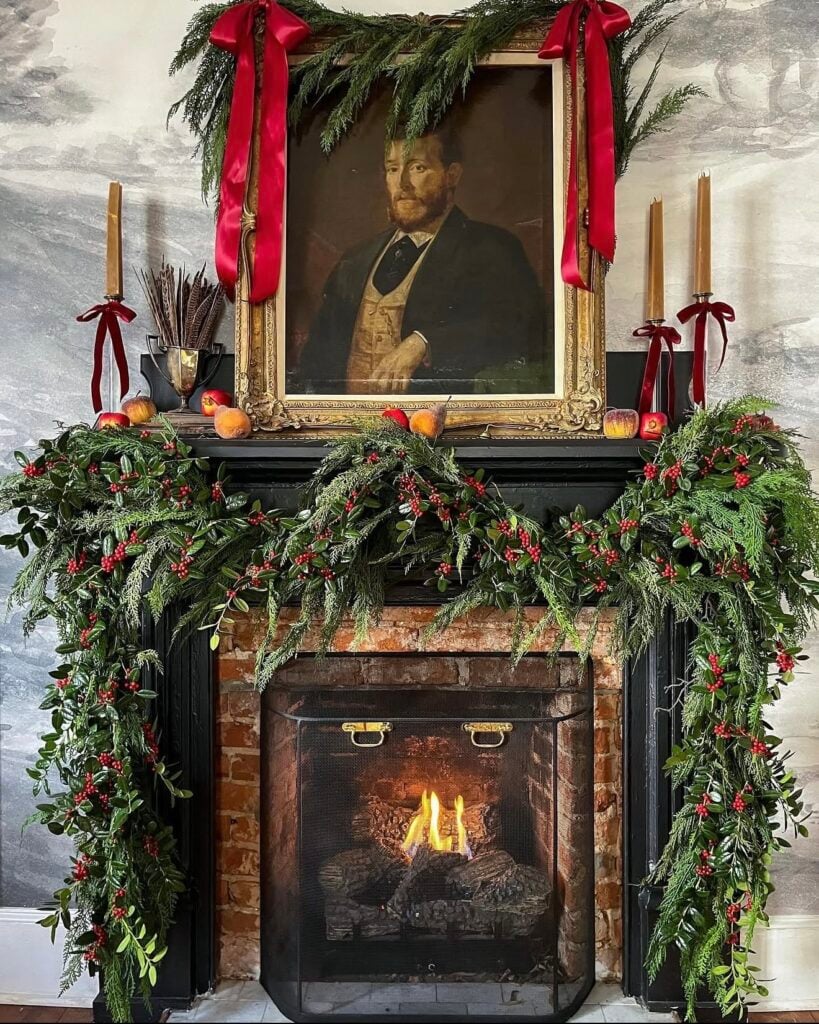 Sophisticated old money Christmas mantel with layered greenery and elegant traditional holiday accents with oil painting over fireplace