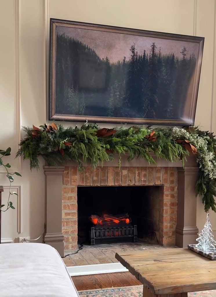 Subtle Christmas fireplace mantel with simple greenery, understated holiday decorations, and a soft neutral color palette.