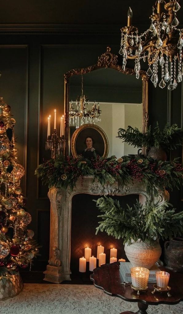 Victorian-inspired Christmas fireplace mantel with ornate holiday decorations, greenery, candles, and elegant traditional details.