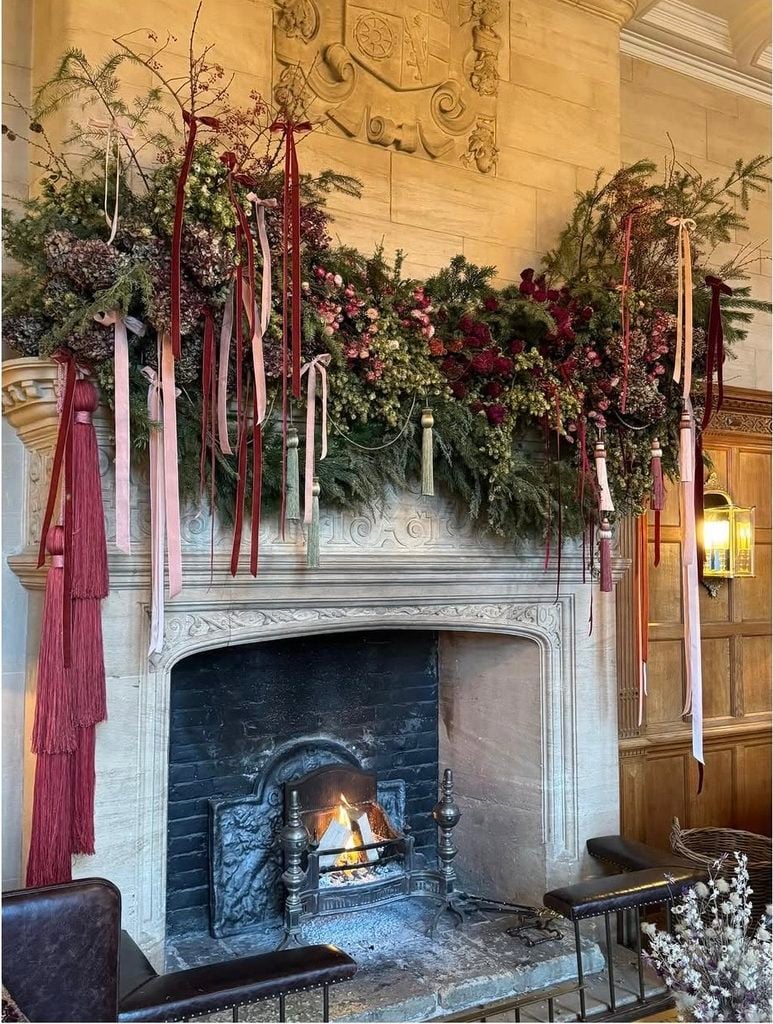 Vintage Christmas fireplace mantel decorated with nostalgic holiday pieces, greenery, candles, and old-fashioned seasonal charm.