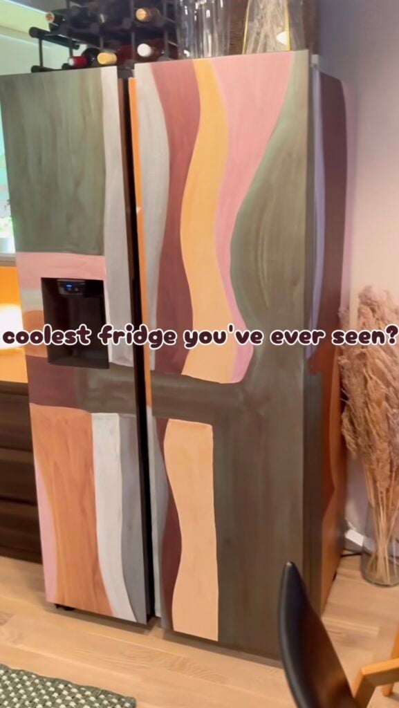 Refrigerator transformed with artistic patterned wallpaper as a statement kitchen feature.