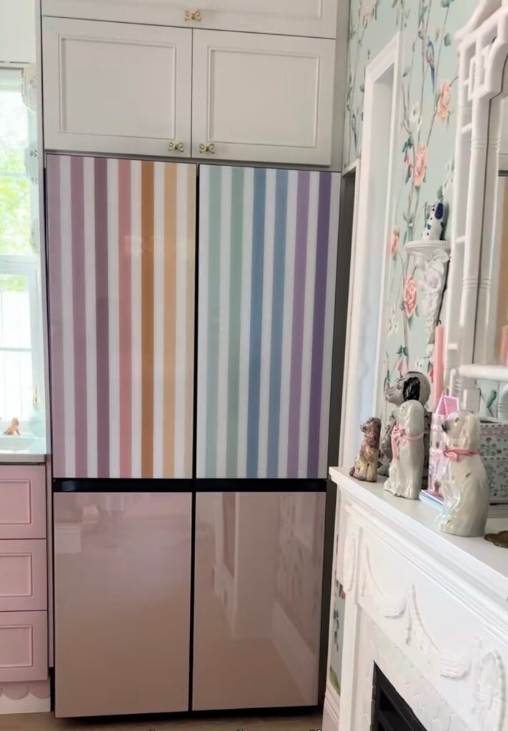 Refrigerator with colorful striped wallpaper covering part of the appliance for a bold two-tone look.