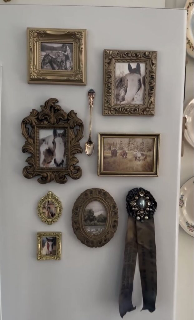 Vintage-inspired fridge gallery wall on a white refrigerator with ornate framed horse photos, landscape art, a decorative spoon and an equestrian award ribbon.