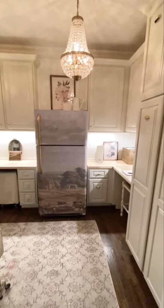 Refrigerator decorated with patterned wallpaper in a nature scene to create an artistic focal point in the room.