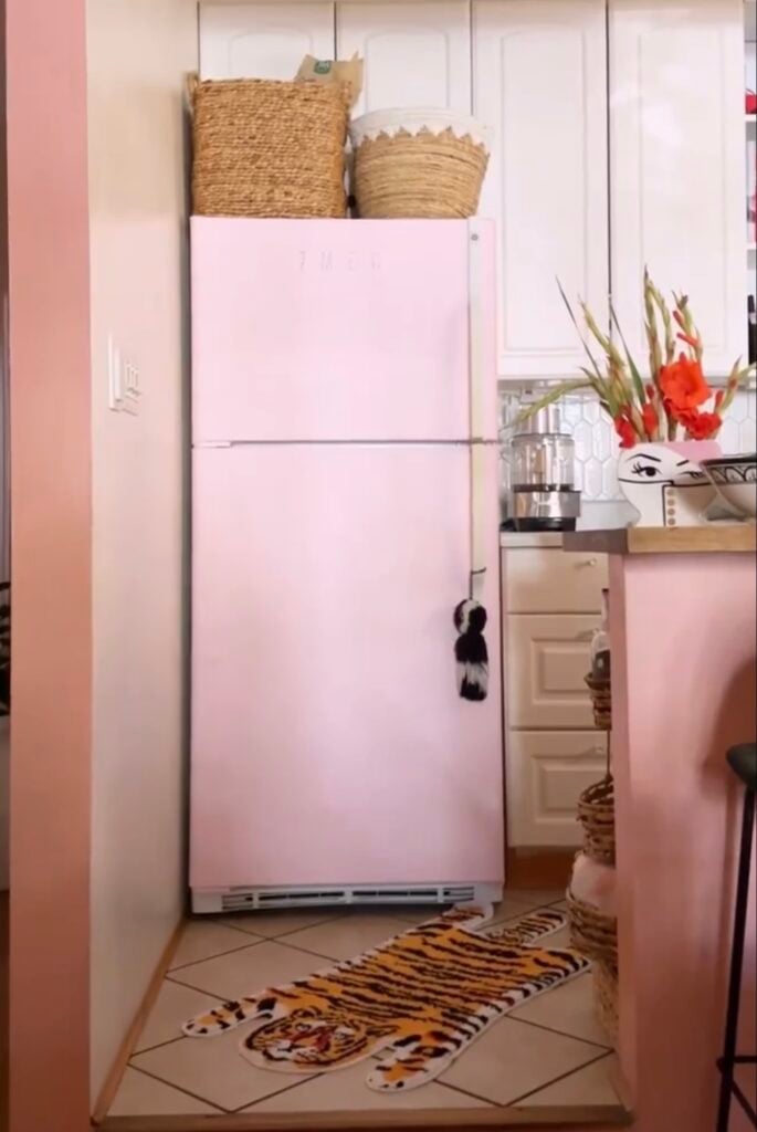 Refrigerator decorated with soft pink wallpaper for a colorful kitchen makeover.