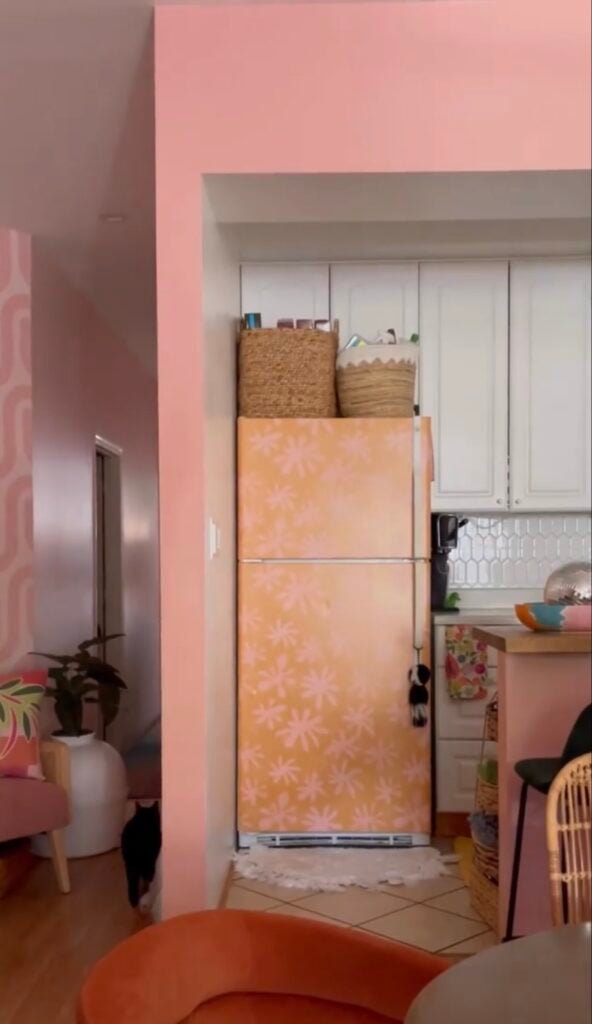 Refrigerator featuring bold decorative wallpaper as a statement piece in the kitchen.