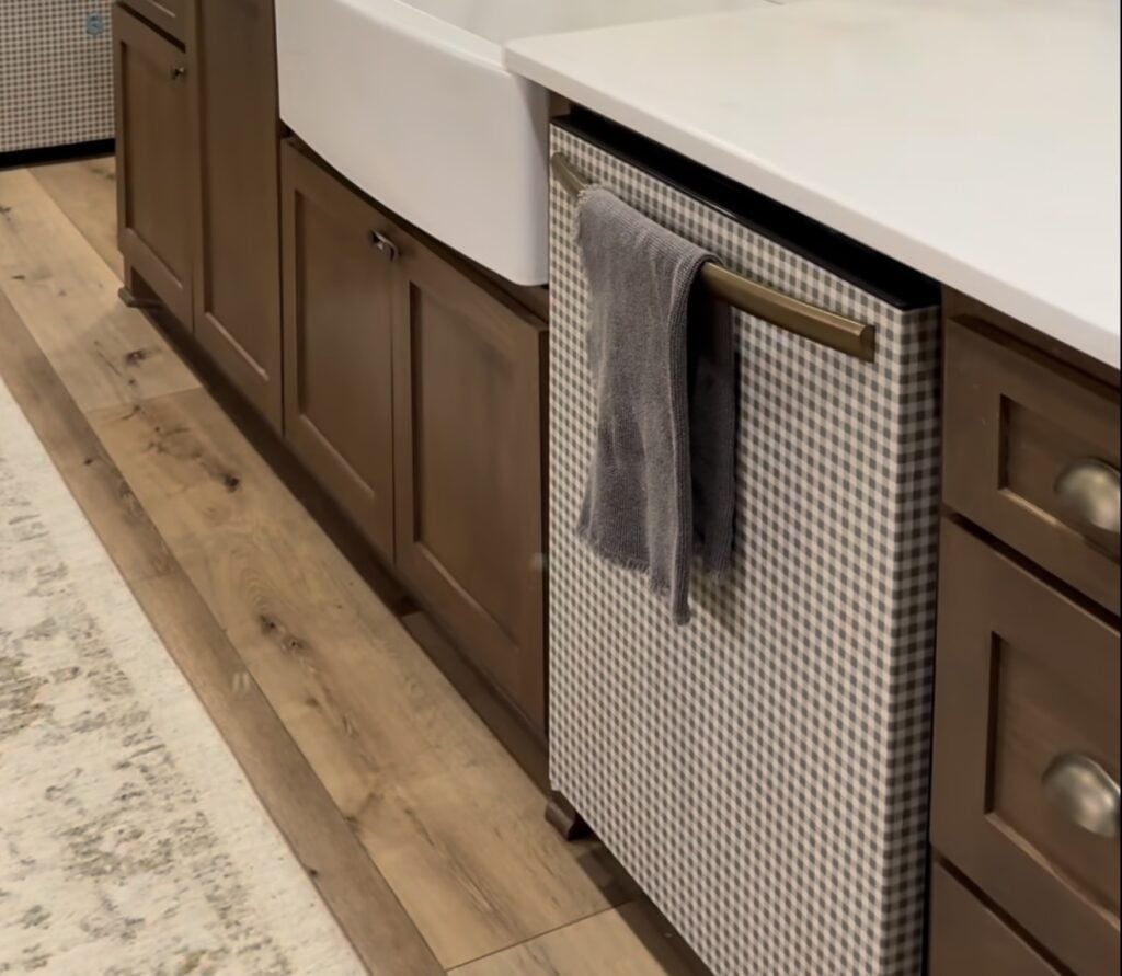 Dishwasher covered in decorative wallpaper to create a statement appliance in the kitchen.