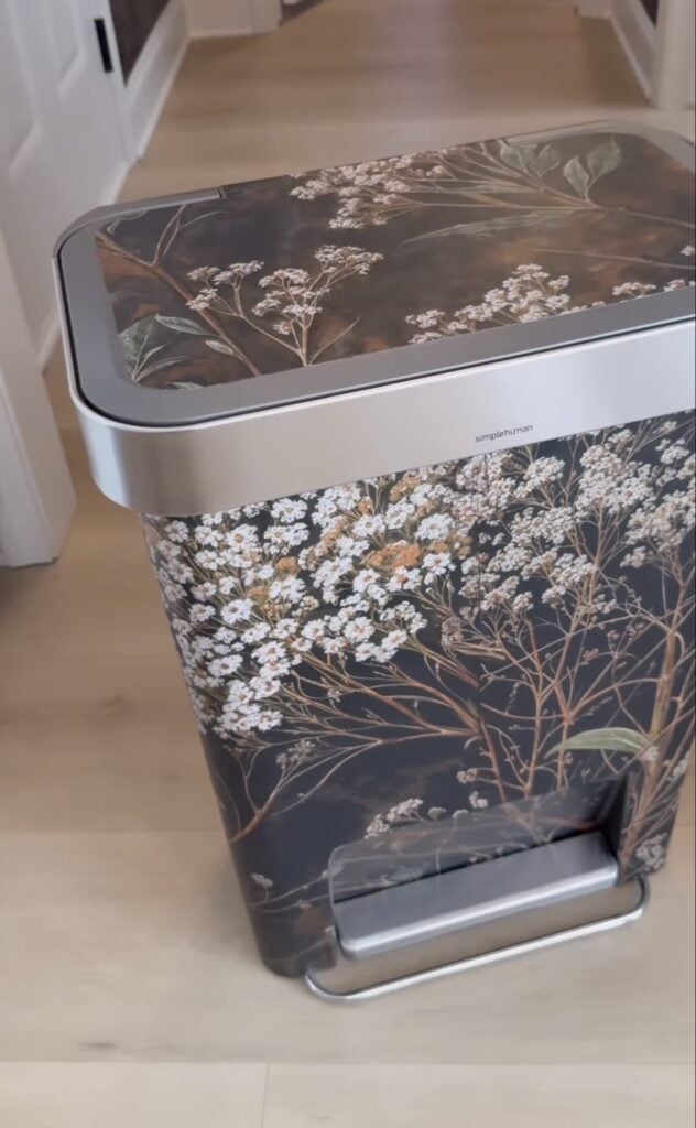 Trash can covered in bold patterned wallpaper as a creative small decorating project.
