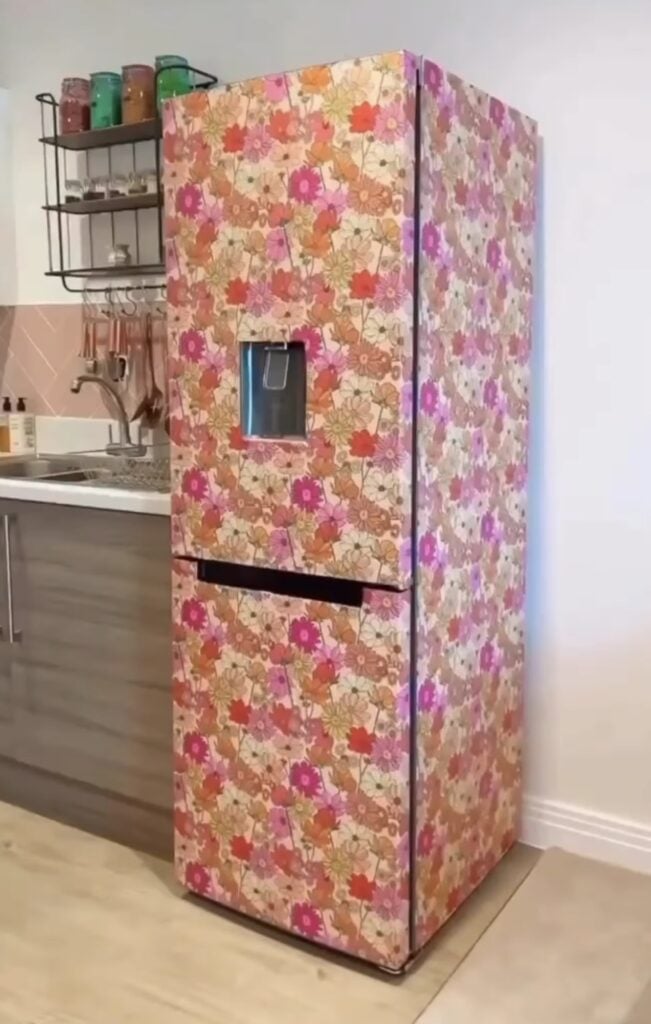 Refrigerator decorated with colorful wallpaper for a creative appliance makeover.
