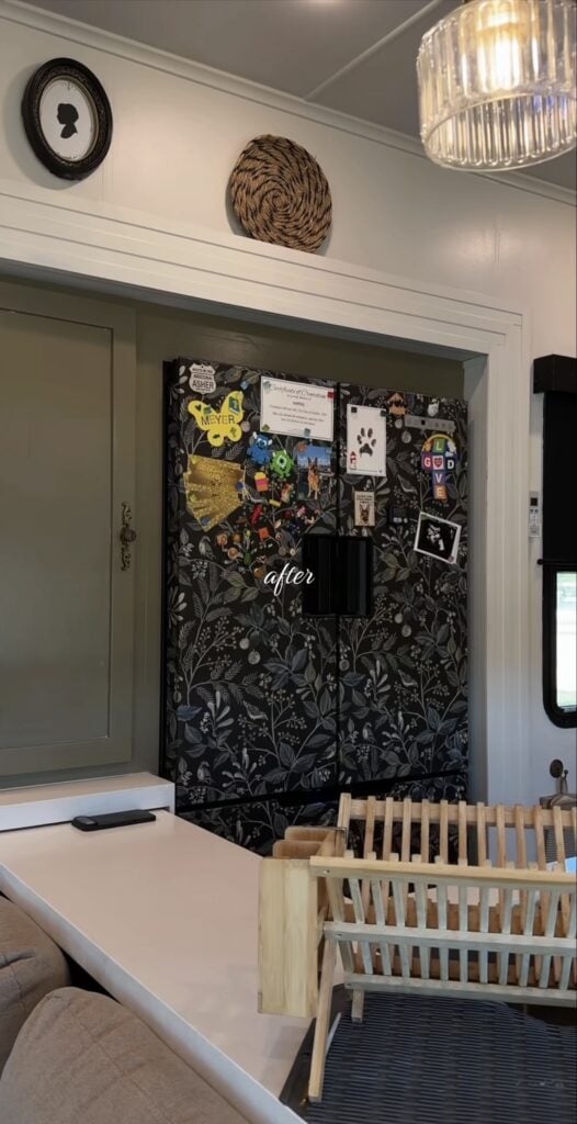 Refrigerator transformed with dark wallpaper for a dramatic kitchen design feature.